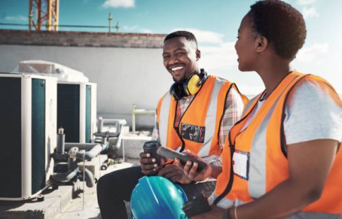 Shot of a young man and woman having a coffee break at a construction site